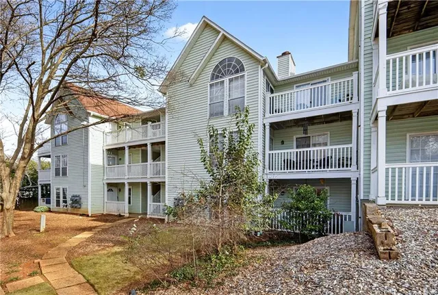 a front view of a residential apartment building with a yard