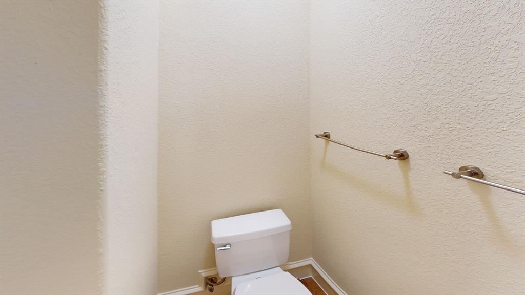 4516 Gilbert Avenue Dallas, TX 75219 - Photo 21 of 28 White toilet with brushed nickel flush lever