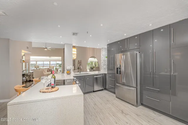 a kitchen with sink refrigerator and stove