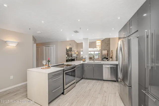 a kitchen with a sink stove and refrigerator