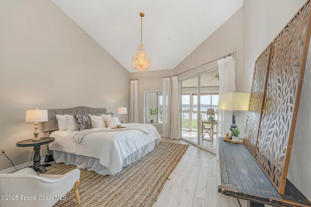 a spacious bedroom with a bed and a large window