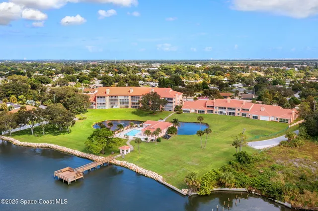 an aerial view of residential houses with outdoor space and swimming pool