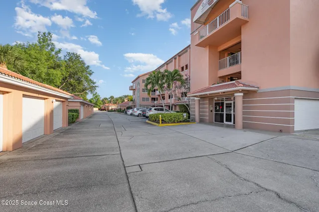 a view of a tall building next to a yard