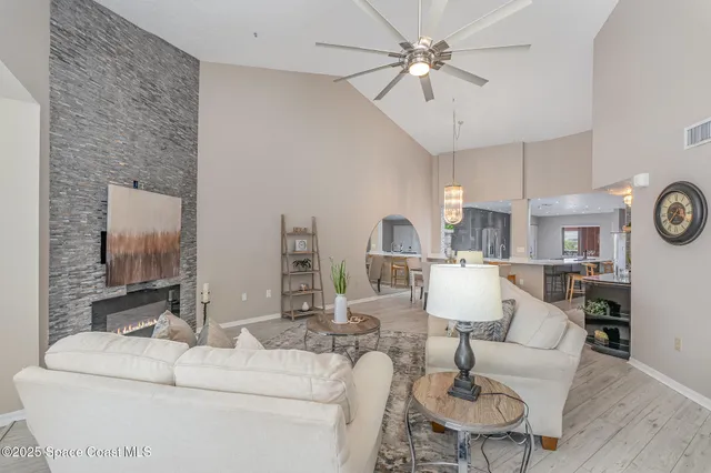 a living room with furniture and a large mirror