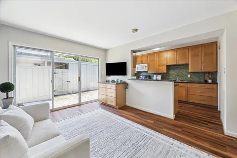 a kitchen with stainless steel appliances granite countertop a stove a sink and a microwave