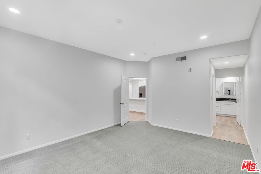 4477 Woodman Avenue, Unit 207 Sherman Oaks, CA 91423 - Photo 11 of 34 a view of a big room with closet and windows