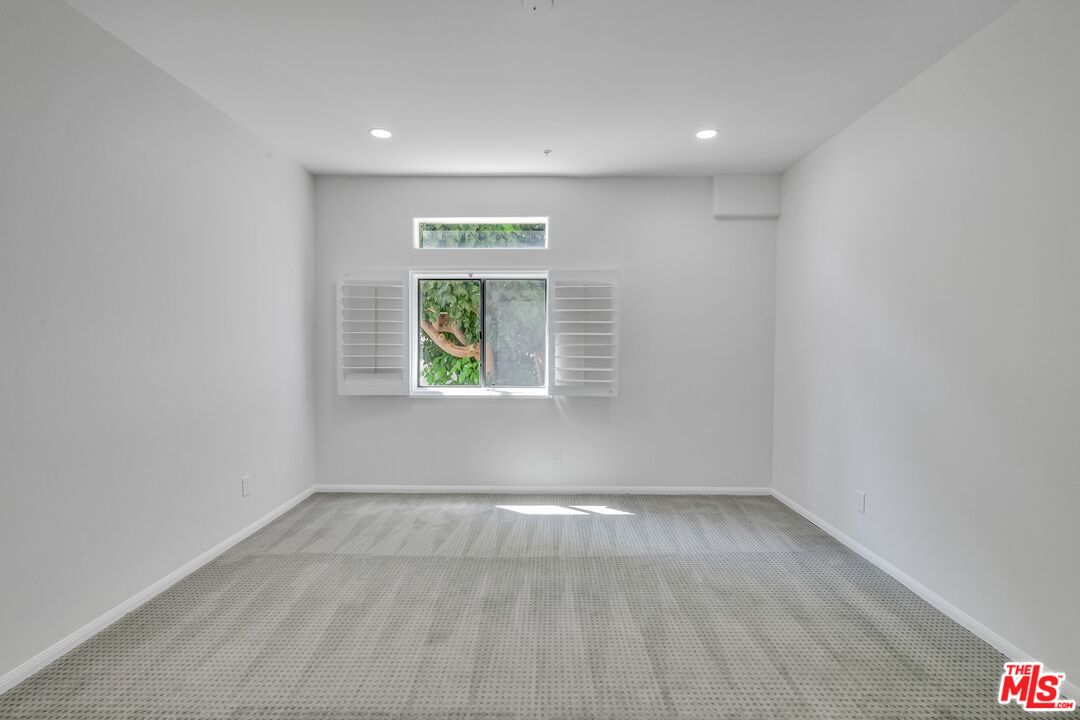 4477 Woodman Avenue, Unit 207 Sherman Oaks, CA 91423 - Photo 13 of 34 a view of an empty room with a window