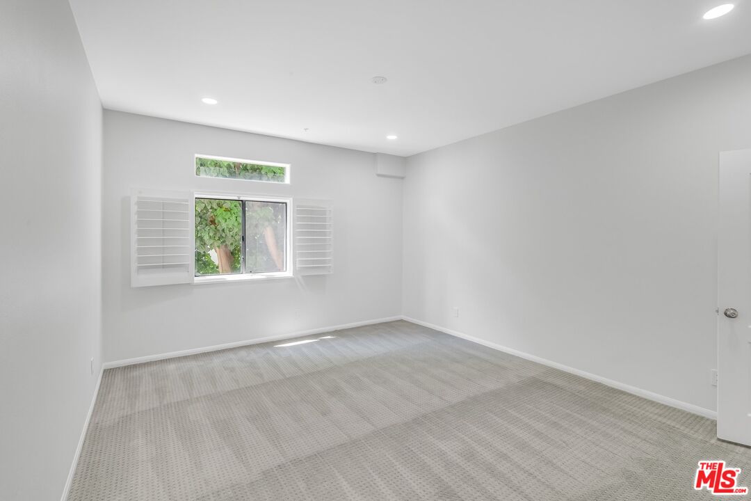 4477 Woodman Avenue, Unit 207 Sherman Oaks, CA 91423 - Photo 14 of 34 an empty room with windows