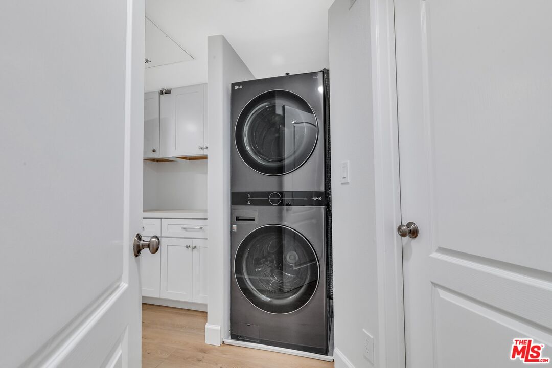 4477 Woodman Avenue, Unit 207 Sherman Oaks, CA 91423 - Photo 20 of 34 a view of a hallway with washer and dryer