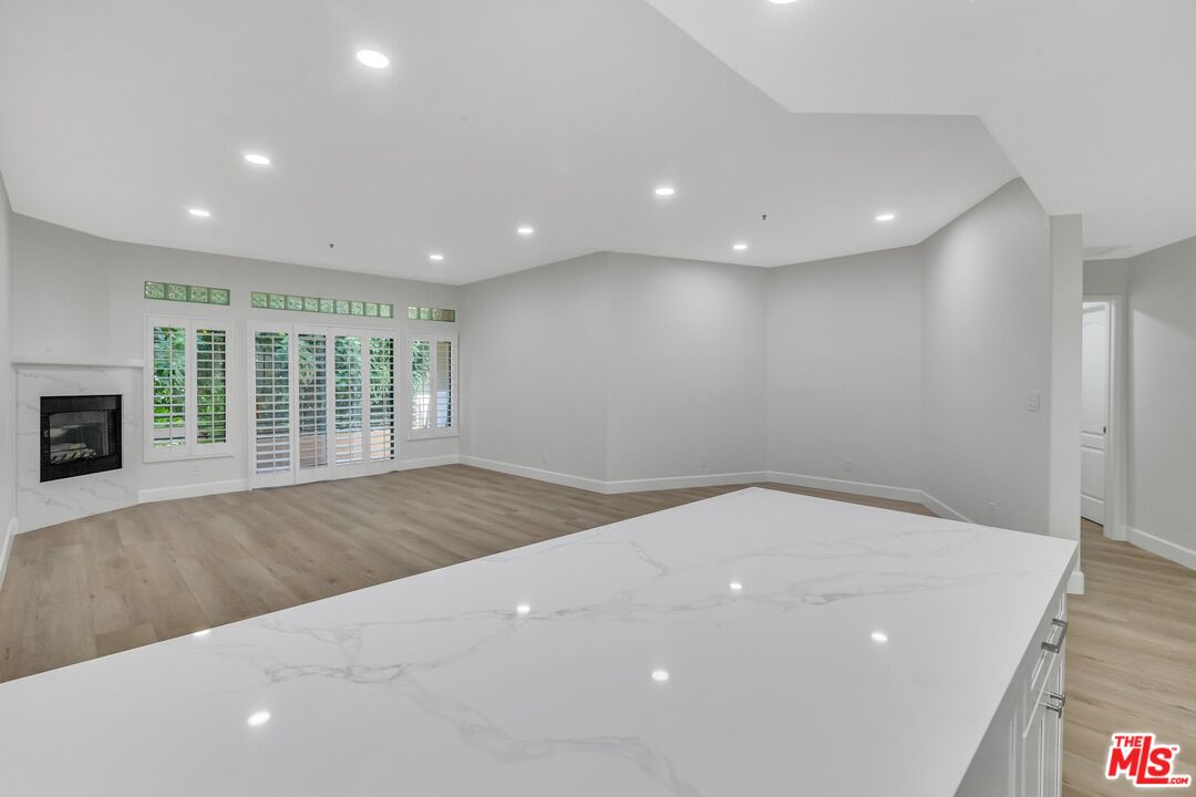 4477 Woodman Avenue, Unit 207 Sherman Oaks, CA 91423 - Photo 2 of 34 a view of an empty room with a window and fireplace