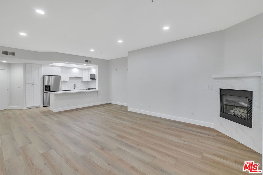 4477 Woodman Avenue, Unit 207 Sherman Oaks, CA 91423 - Photo 6 of 34 a view of empty room with wooden floor