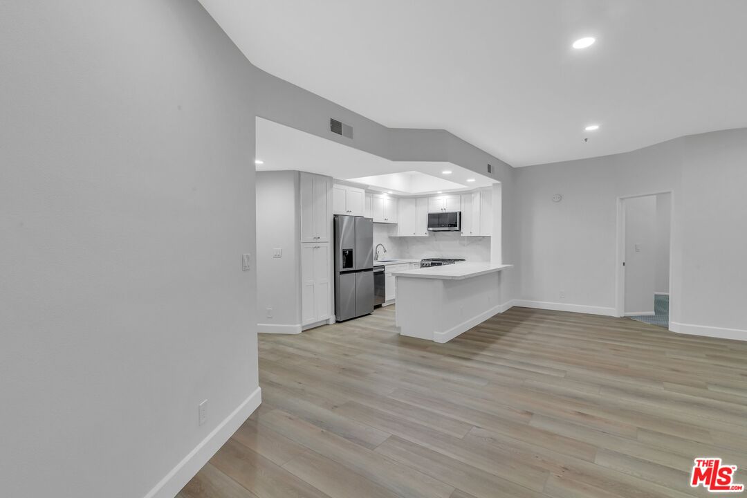 4477 Woodman Avenue, Unit 207 Sherman Oaks, CA 91423 - Photo 9 of 34 a view of kitchen with wooden floor
