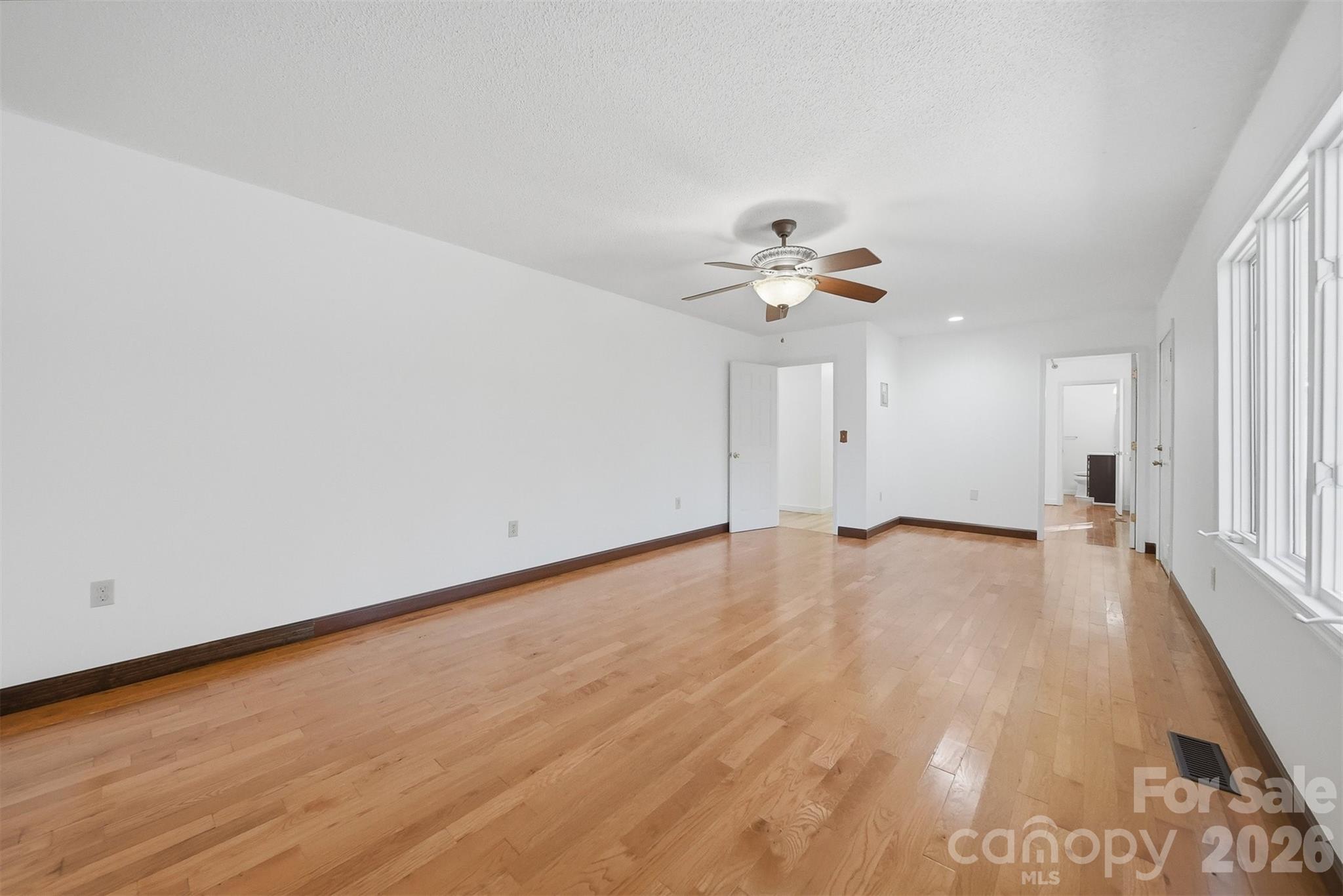 4771 Petra Mill Road Granite Falls, NC 28630 - Photo 25 of 46 a view of an empty room with wooden floor and a window