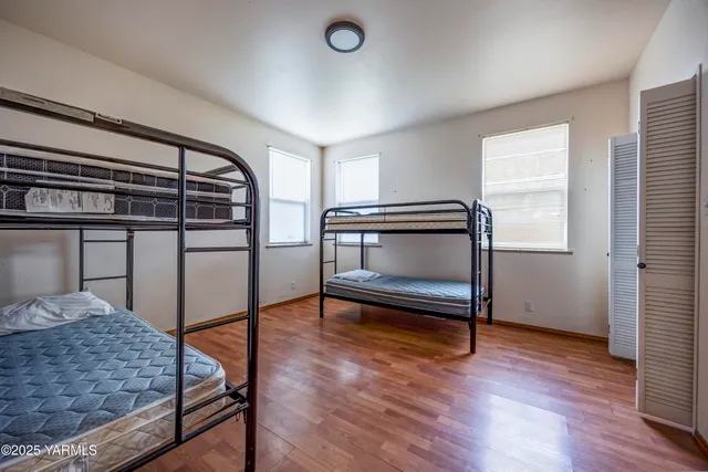 a bedroom with a bunk bed and a window