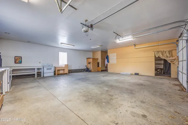 a view of a kitchen with a sink and a refrigerator