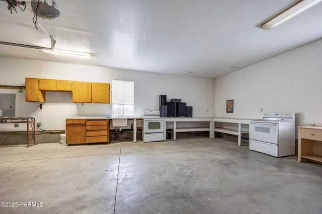 a kitchen with stainless steel appliances granite countertop a refrigerator a stove and a wooden floors