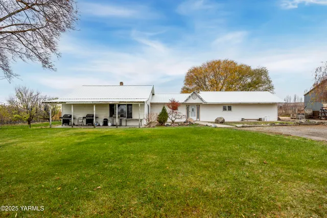 a large kitchen with stainless steel appliances granite countertop a large counter top a stove and a refrigerator