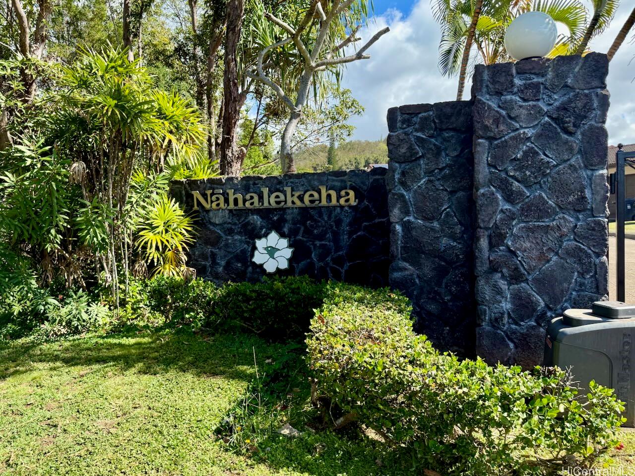 98-1421 Onikiniki Place, Unit 5 Aiea, HI 96701 - Photo 22 of 23 a sign that is sitting in front of flowers