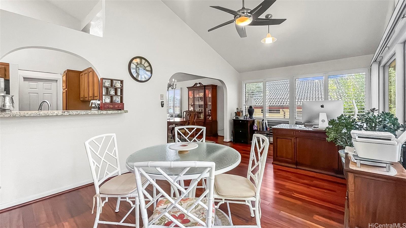 98-1421 Onikiniki Place, Unit 5 Aiea, HI 96701 - Photo 5 of 23 a view of a dining room with furniture window and wooden floor