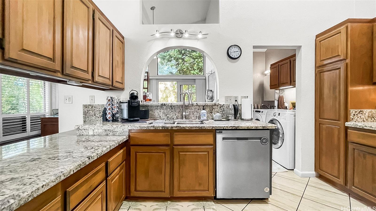 98-1421 Onikiniki Place, Unit 5 Aiea, HI 96701 - Photo 8 of 23 a kitchen with stainless steel appliances granite countertop a stove a sink and a refrigerator