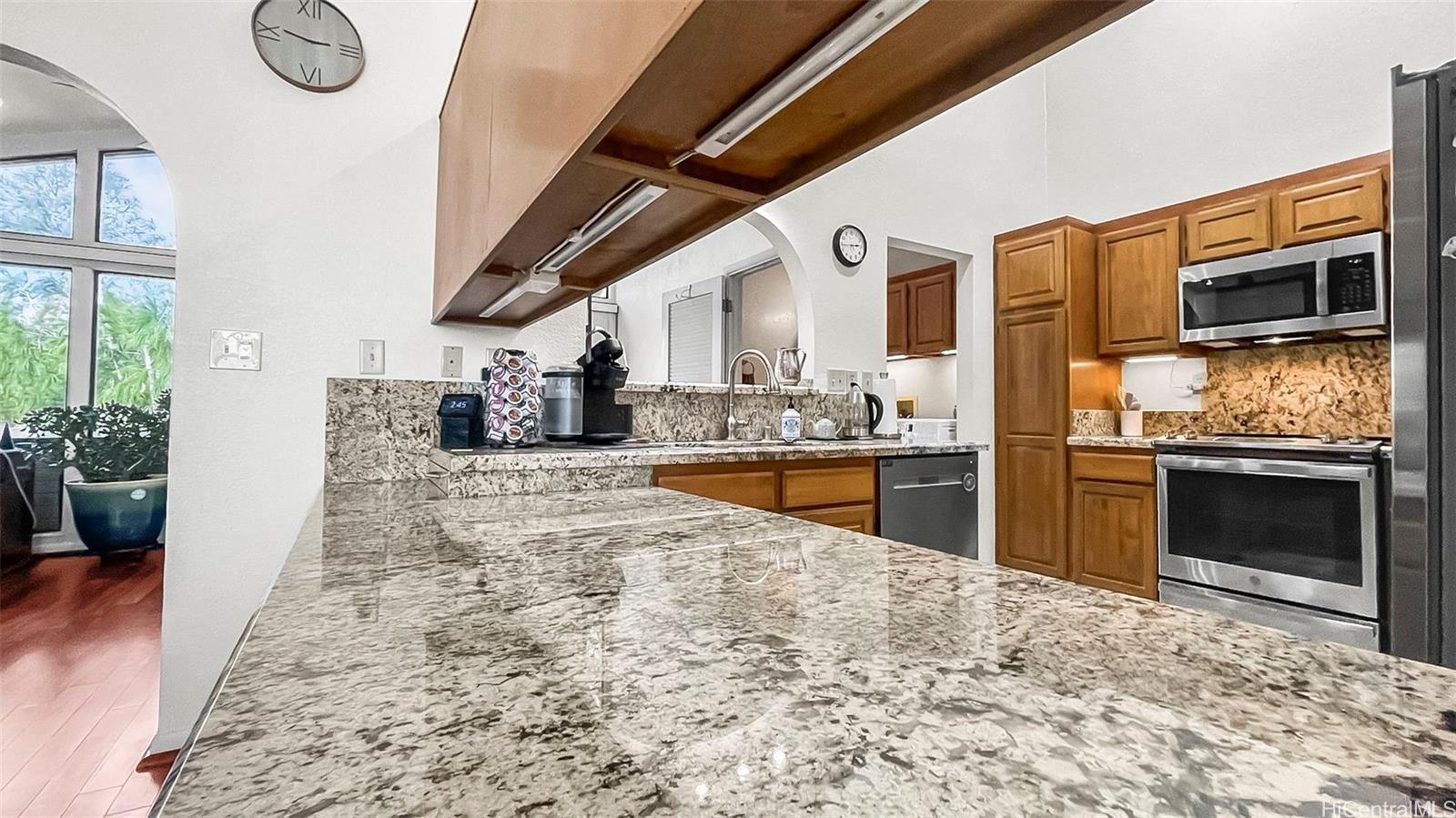 98-1421 Onikiniki Place, Unit 5 Aiea, HI 96701 - Photo 9 of 23 a view of a kitchen with a sink and cabinets