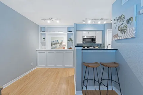 a living room with a fireplace and a chandelier