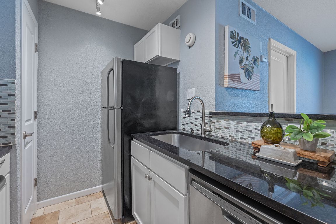 3204 Menchaca Road, Unit 303 Austin, TX 78704 - Photo 16 of 26 a kitchen with stainless steel appliances granite countertop a refrigerator and a stove