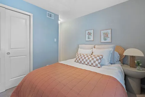 a bedroom with a bed and a lamp