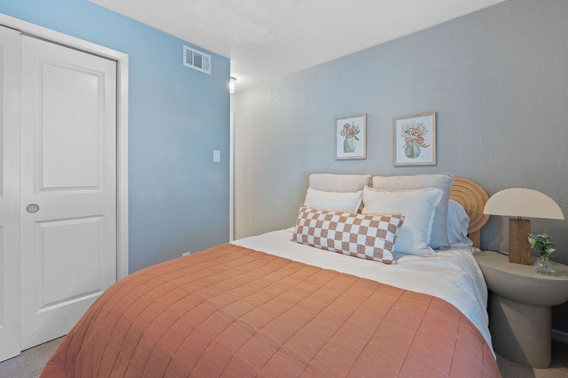 3204 Menchaca Road, Unit 303 Austin, TX 78704 - Photo 17 of 26 a bedroom with a bed and a lamp