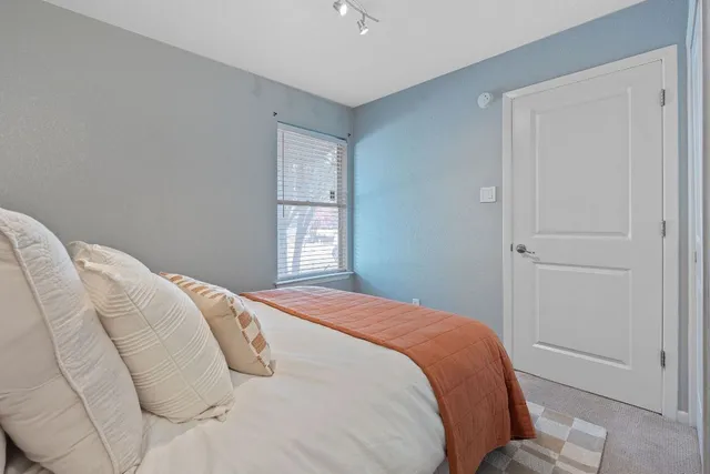 a bedroom with a bed and a window