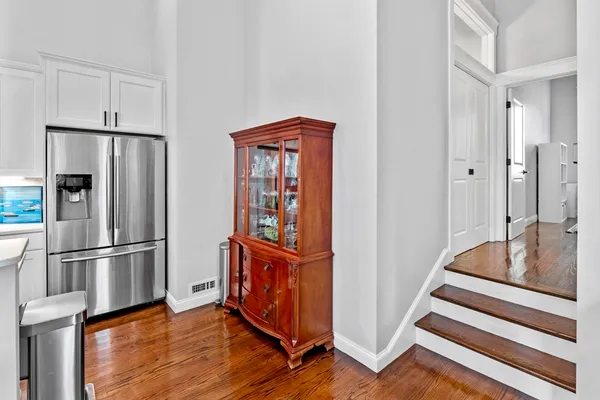 a kitchen with stainless steel appliances granite countertop a refrigerator and a stove top oven