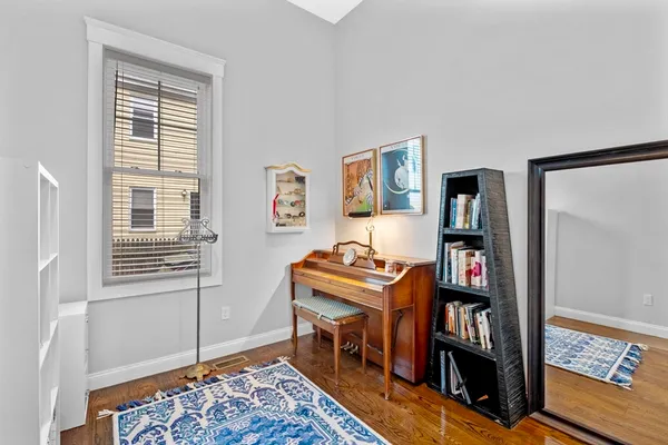 a room with a book shelf and a window