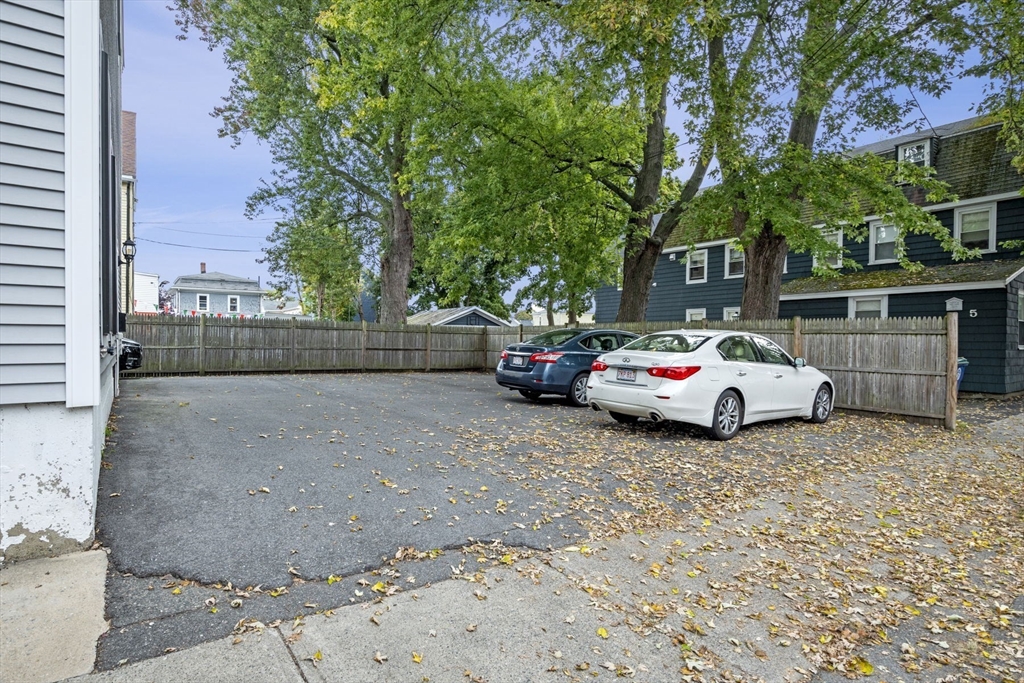 85 Bridge Street, Unit 3 Salem, MA 01970 - Photo 24 of 31 a white house that has a tree on the side of it