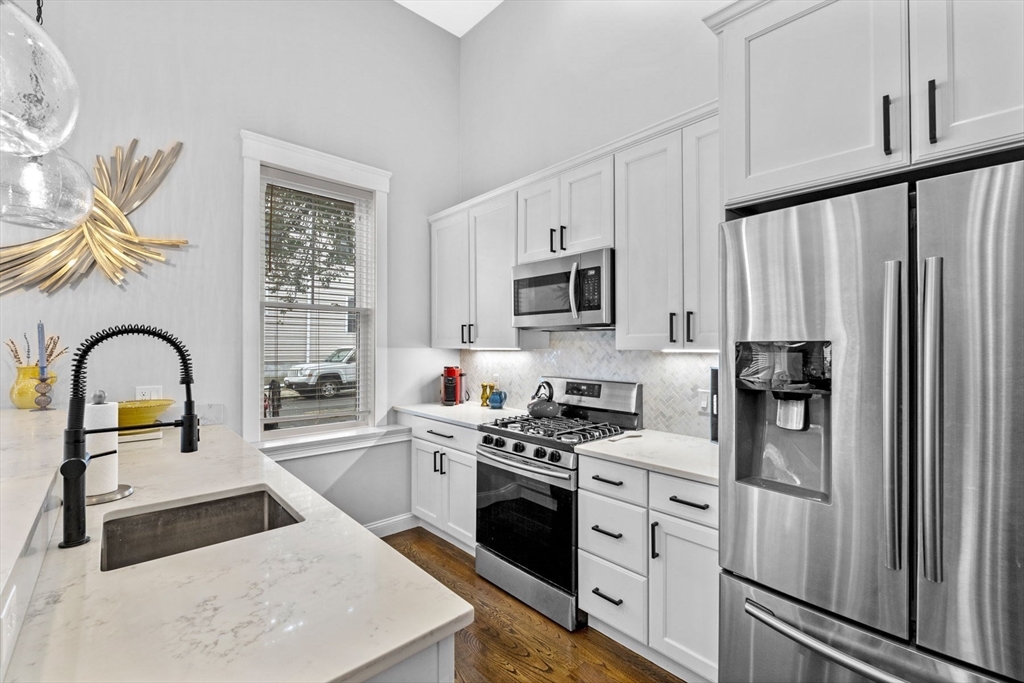 85 Bridge Street, Unit 3 Salem, MA 01970 - Photo 6 of 31 a kitchen with stainless steel appliances granite countertop a refrigerator sink and stove