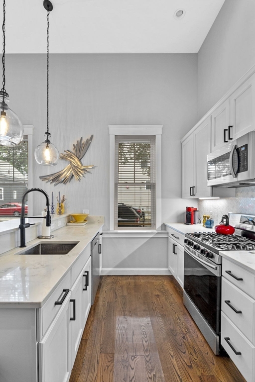 85 Bridge Street, Unit 3 Salem, MA 01970 - Photo 7 of 31 a kitchen that has a lot of cabinets in it and wooden floors