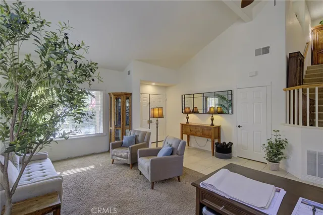 a living room with furniture and a potted plant