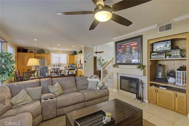 a living room with furniture fireplace and stainless steel appliances