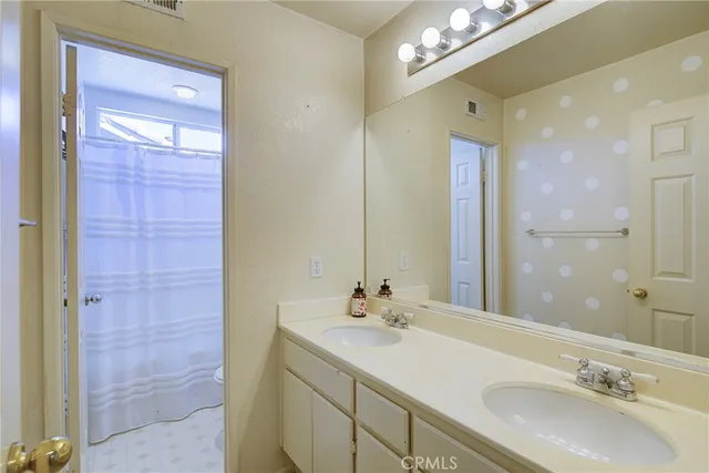 a bathroom with a sink double vanity and a mirror