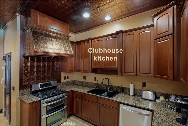 a kitchen with granite countertop a sink stove and cabinets