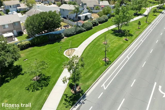 an aerial view of a house with a yard and large trees