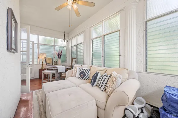 a bedroom with furniture and large windows