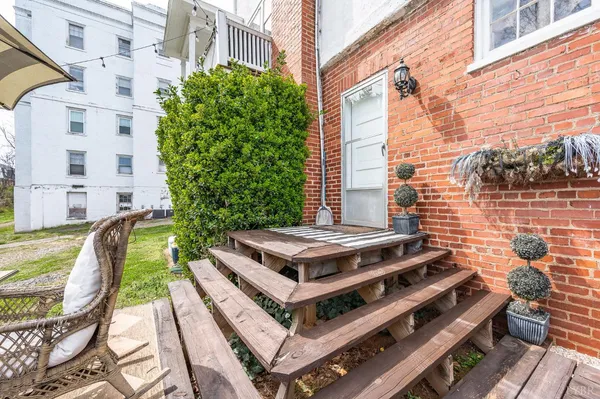 a view of a patio with couches chairs and potted plants