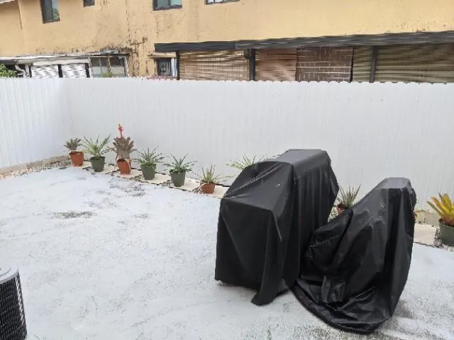 a backyard of a house with table and chairs