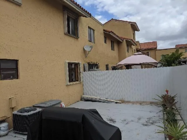 a couple of cars parked in front of a house