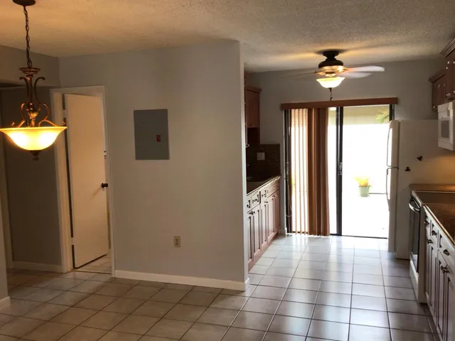 a bathroom with a granite countertop bathtub shower and toilet
