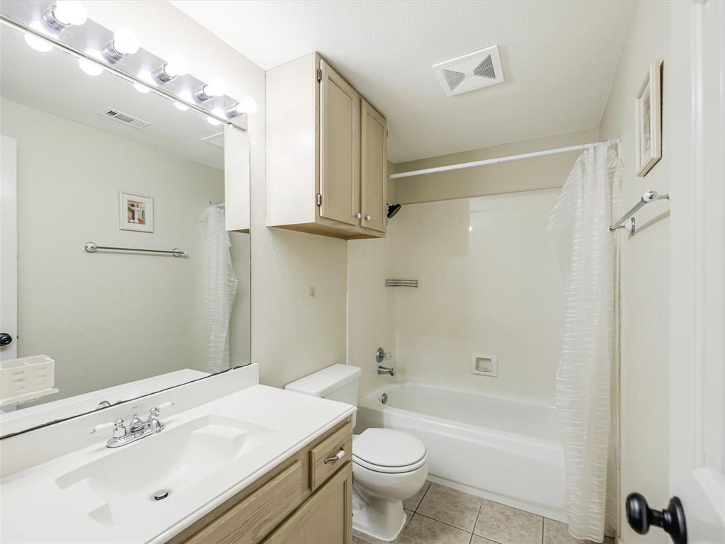 7836 Tournament Road Frisco, TX 75035 - Photo 19 of 23 Bathroom featuring a vanity with integrated sink, chrome-finish faucet, full-width mirror, and overhead lighting