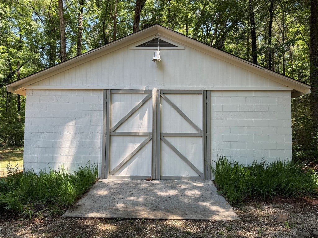 306 Crawford Road Opelika, AL 36804 - Photo 23 of 31 This versatile outbuilding offers practical storage solutions with a clean and classic aesthetic.