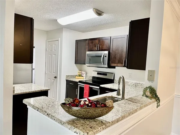 a white toilet sitting next to a white sink
