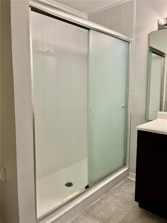 a bathroom with a shower and a bath tub