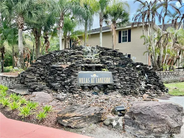 a front view of multiple houses with a yard